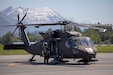 Pilots and crew members of the Alaska Army National Guard's 1st Battalion, 207th Aviation Regiment prepare to fly ground search and rescue teams with Alaska Mountain Rescue Group and MAT+SAR Search & Rescue to various locations on Pioneer Peak near Palmer, AK, to search for a missing hiker, June 15, 2021. (U.S. Army National Guard photo by Spc. Grace Nechanicky)