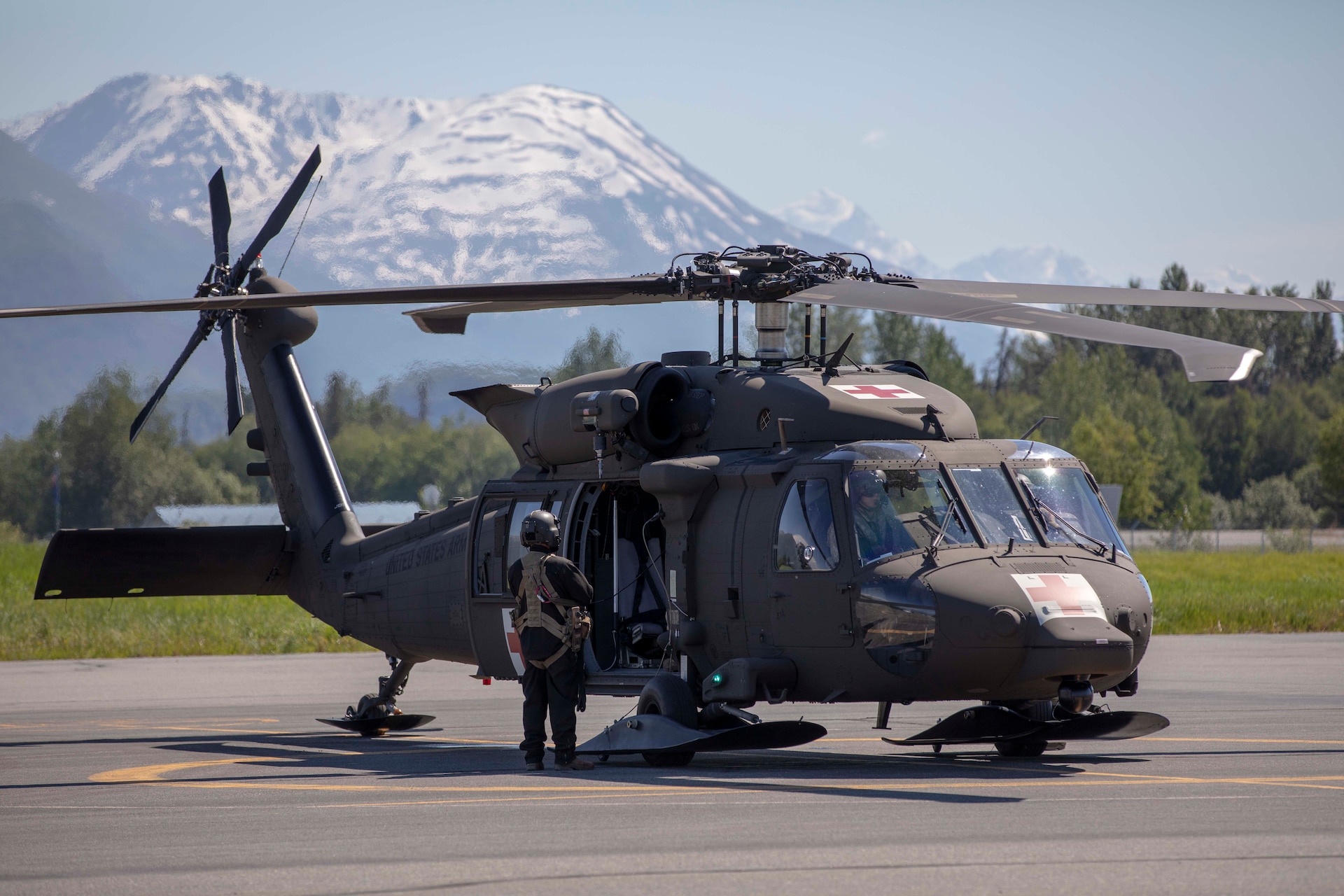 Pilots and crew members of the Alaska Army National Guard's 1st Battalion, 207th Aviation Regiment prepare to fly ground search and rescue teams with Alaska Mountain Rescue Group and MAT+SAR Search & Rescue to various locations on Pioneer Peak near Palmer, AK, to search for a missing hiker, June 15, 2021. (U.S. Army National Guard photo by Spc. Grace Nechanicky)
