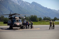 Pilots and crew members of the Alaska Army National Guard's 1st Battalion, 207th Aviation Regiment prepare to fly ground search and rescue teams with Alaska Mountain Rescue Group and MAT+SAR Search & Rescue to various locations on Pioneer Peak near Palmer, AK, to search for a missing hiker, June 15, 2021. (U.S. Army National Guard photo by Spc. Grace Nechanicky)