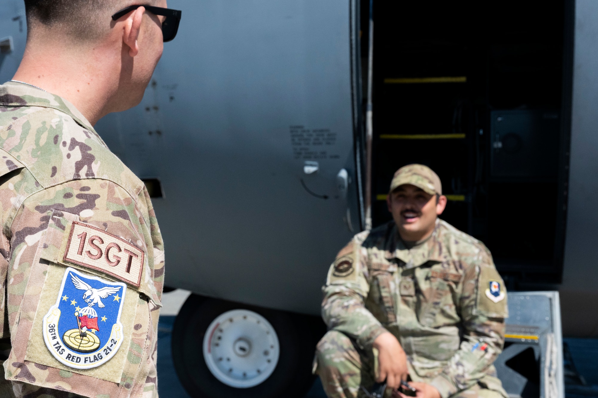 U.S. Space Force Master Sgt. Tyler Duncan chats with U.S. Air Force Staff Sgt. Jeremiah Stone, 374th Air Maintenance Squadron crew chief, during RED FLAG-Alaska 21-2 at Joint Base Elmendorf-Richardson, Alaska, June 15, 2021. Duncan is the first Guardian supporting JBER RF-A 21-2. Approximately 1,500 service members are expected to fly, maintain and support more than 100 aircraft from more than 100 units during this iteration of the exercise. (U.S. Air Force photo by Sheila deVera)