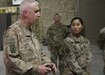 The Commanding General of the 1st Theater Sustainment Command, Maj. Gen. John P. Sullivan, stands with Sgt. 1st Class Michelle Metzger, the senior enlisted advisor for the Fort Bragg, N.C., based 151th Quartermaster Detachment, moments before the general presented his command coin to riggers, Spc. Paulo Paulo and Sgt. Joshua Parkinson, during his June 10, 2021 visit. Metzger recommended the riggers for their hard work and dedication during the deployment.