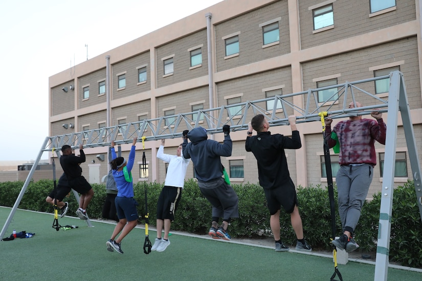 Maj. Anthony Sims-Hall, 1st Theater Sustainment Command, theater mortuary affairs officer, leads a functional fitness workout for Soldiers at Camp Arifjan, Kuwait. Maj. Sims-Hall takes personal passion and hobbies and turns them into resiliency opportunities for Soldiers while deployed.
