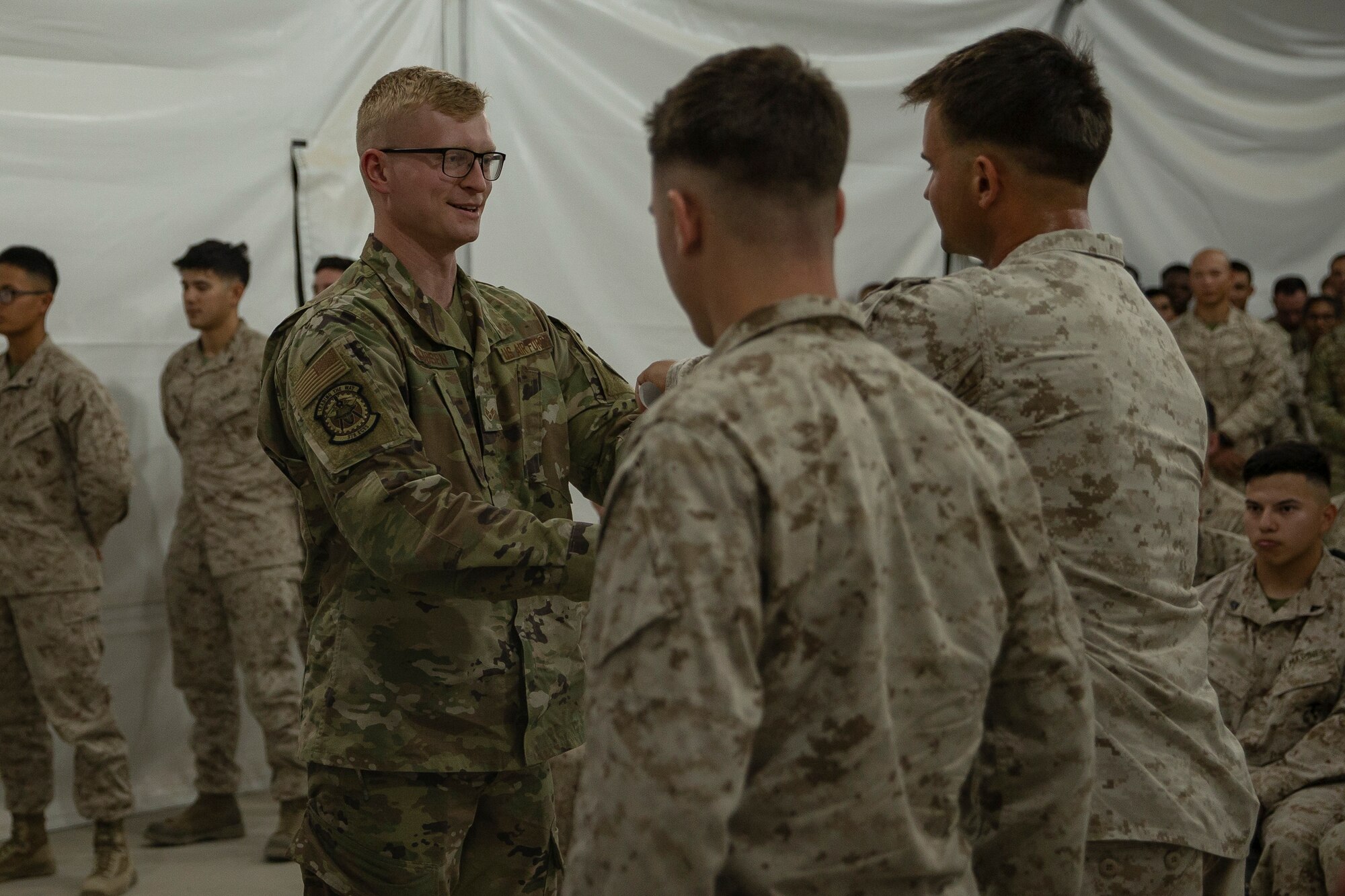 Photo of Airman receiving course certificate.