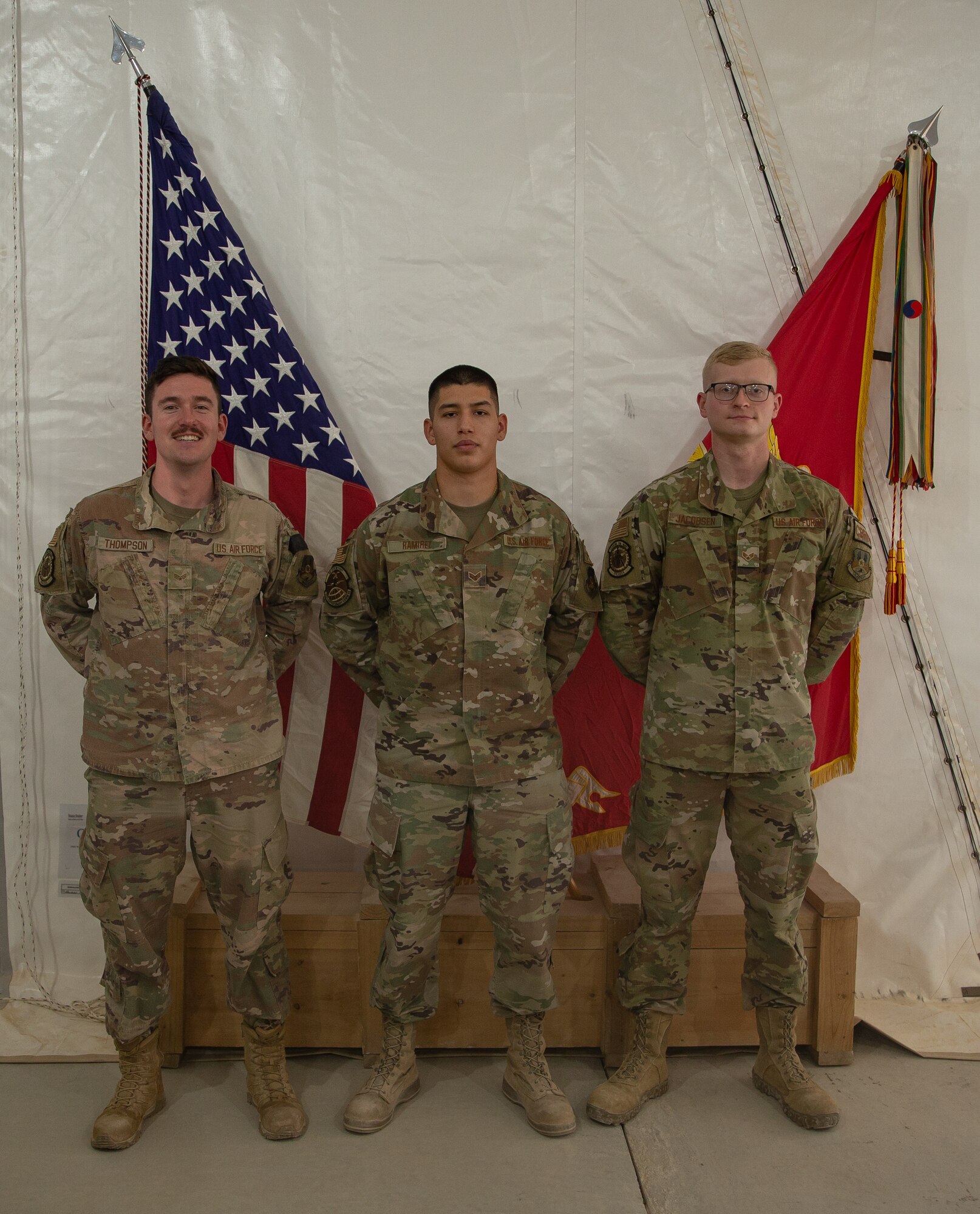Three graduates pose for a photo.