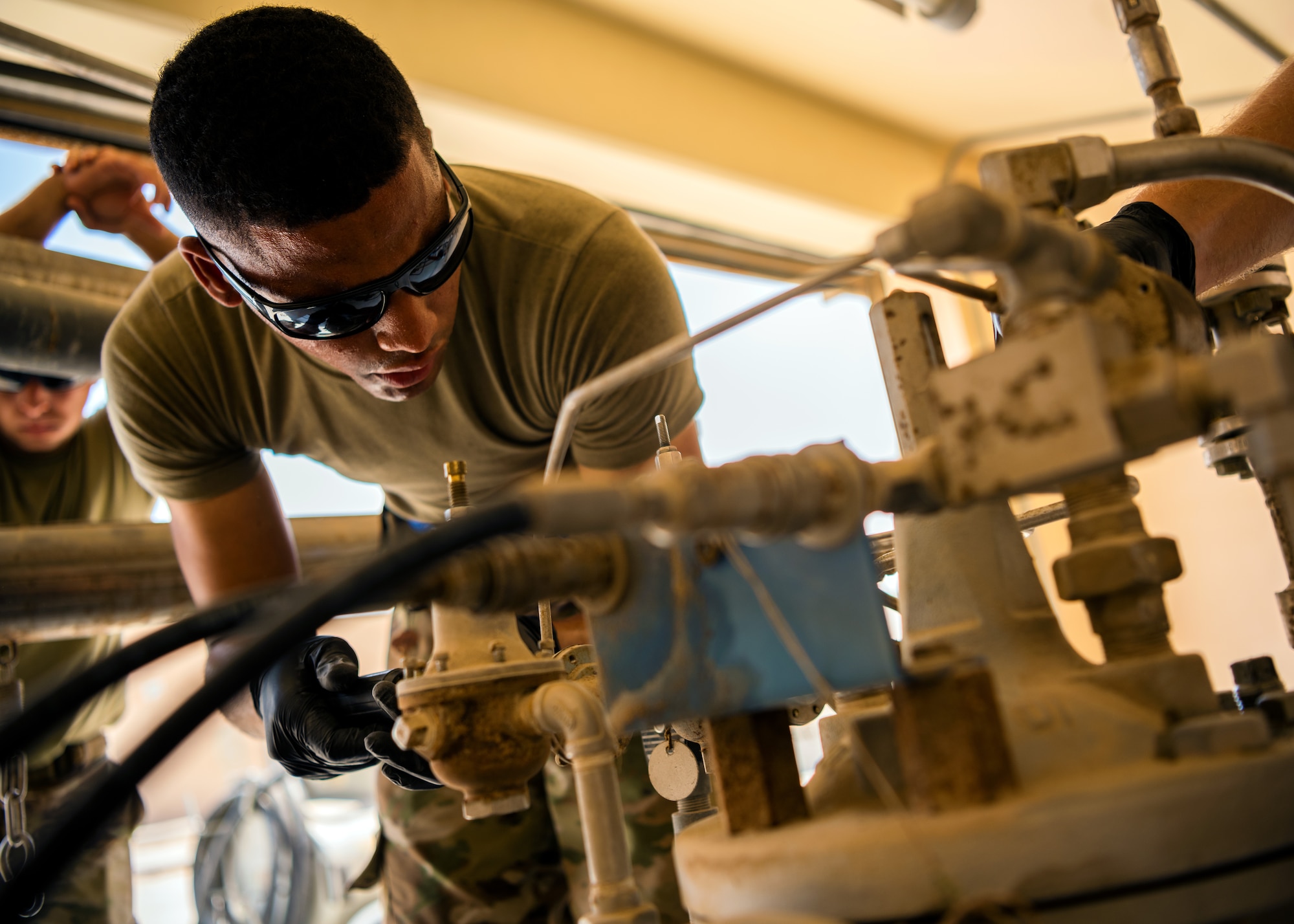 U.S. Air Force Airmen from the 380th Expeditionary Civil Engineer Squadron water & fuel systems maintenance and the 380th Expeditionary Logistic Readiness Squadron fuels flight perform maintenance on a fuels system at Al Dhafra Air Base, United Arab Emirates, June 14, 2021.