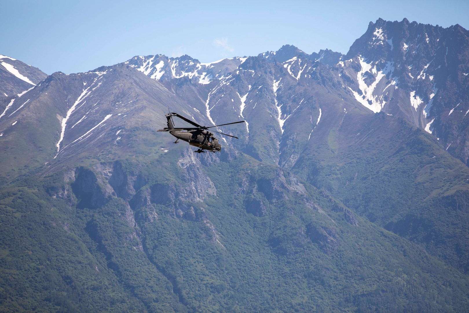 Pilots and crew members of the Alaska Army National Guard's 1st Battalion, 207th Aviation Regiment, fly ground search and rescue teams with Alaska Mountain Rescue Group and MAT+SAR Search & Rescue to locations on Pioneer Peak near Palmer, Alaska, to search for a missing hiker June 15, 2021. The hiker was chased off the trail by bears but emerged and waved down a driver a day and a half after she was last heard from.