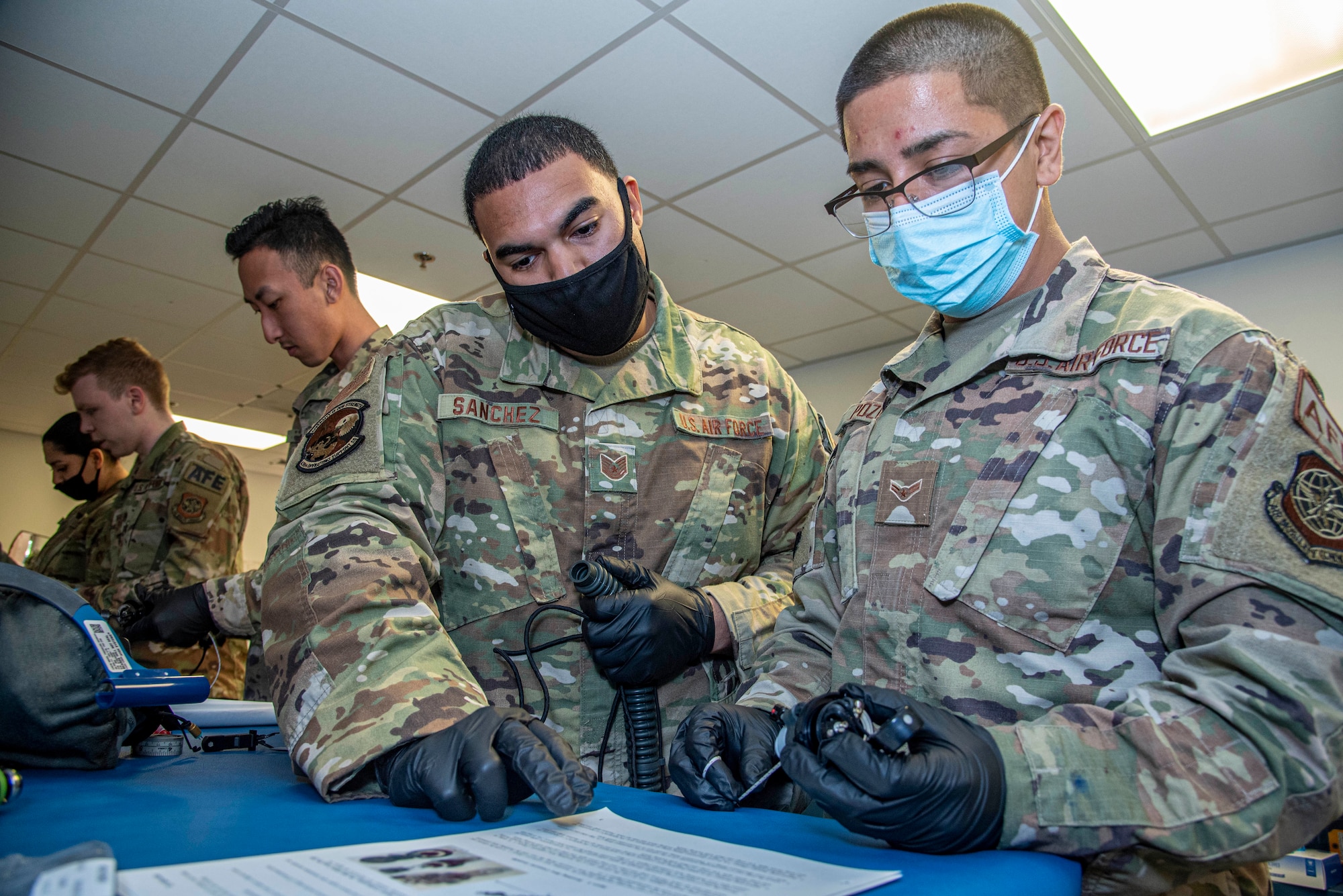 Tech. Sgt. Brian Sanchez, left, and Airman 1st Class Isaiah Pozos, both 436th Operations Support Squadron aircrew flight equipment specialists, test capabilities of the upgraded 358 Quick Don Demist oxygen masks at Dover Air Force Base, Delaware, June 14, 2021. The newly modified masks were tested against the legacy masks to identify and report any deficiencies regarding previously identified fogging issues to Air Mobility Command. (U.S. Air Force photo by Tech. Sgt. Nicole Leidholm)