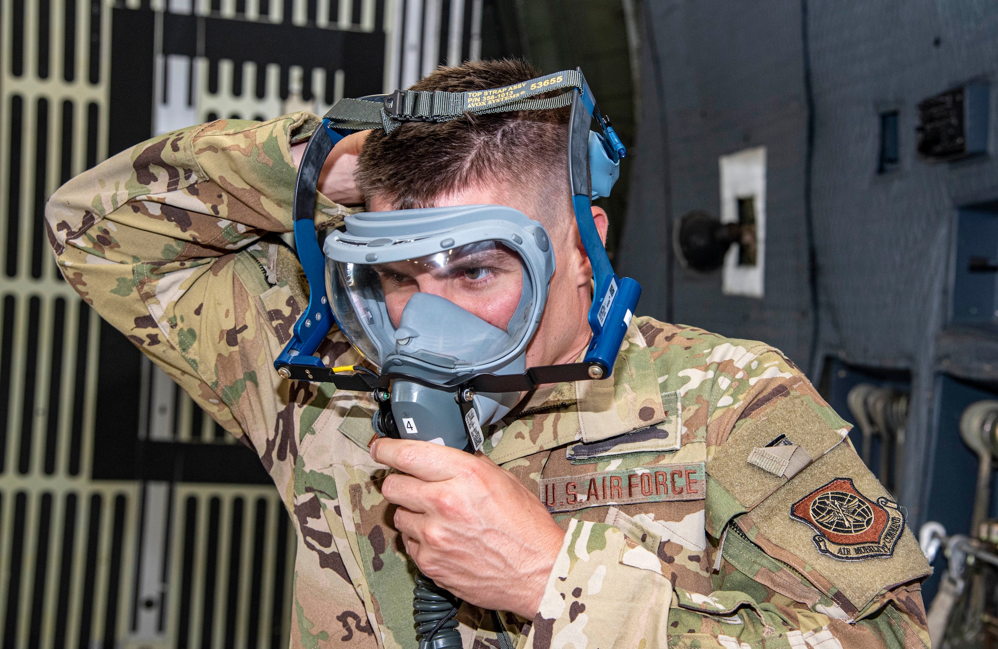 Staff Sgt. Dex Decell, 9th Airlift Squadron loadmaster, dons a 358 Quick Don Demist oxygen mask during a test and evaluation at Dover Air Force Base, Delaware, June 14, 2021. The masks are being tested alongside legacy masks to see how they perform operationally. (U.S. Air Force photo by Tech. Sgt. Nicole Leidholm)