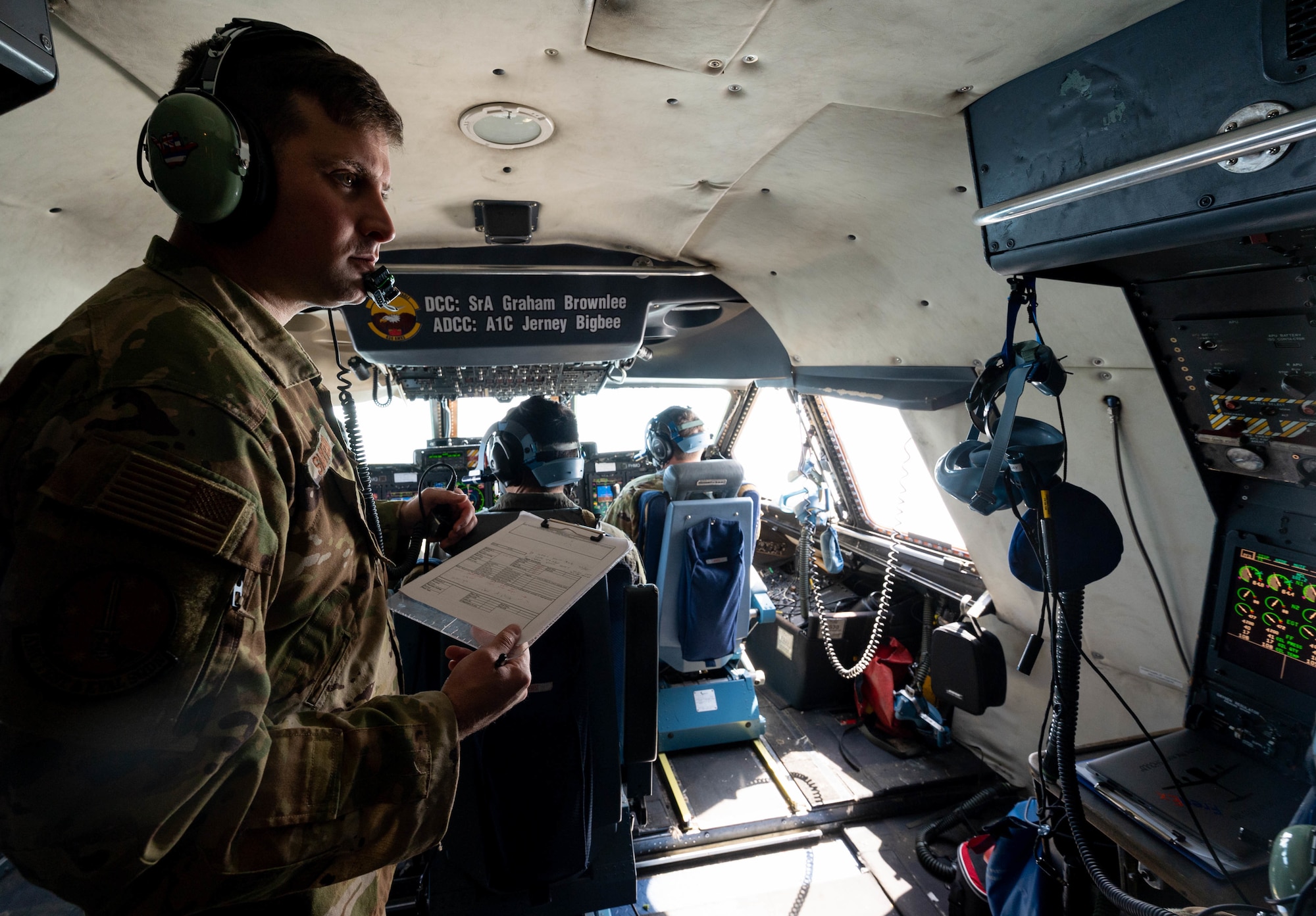 Maj. John Smyrski, Air Mobility Command Test and Evaluation Squadron test director, observes 9th Airlift Squadron aircrew members during a 358 Quick Don Demist oxygen mask training flight, June 15, 2021. The 9th AS aircrew tested mask modifications for AMC’s test and evaluation team which will assist in determining further modifications. (U.S. Air Force photo by Senior Airman Faith Schaefer)