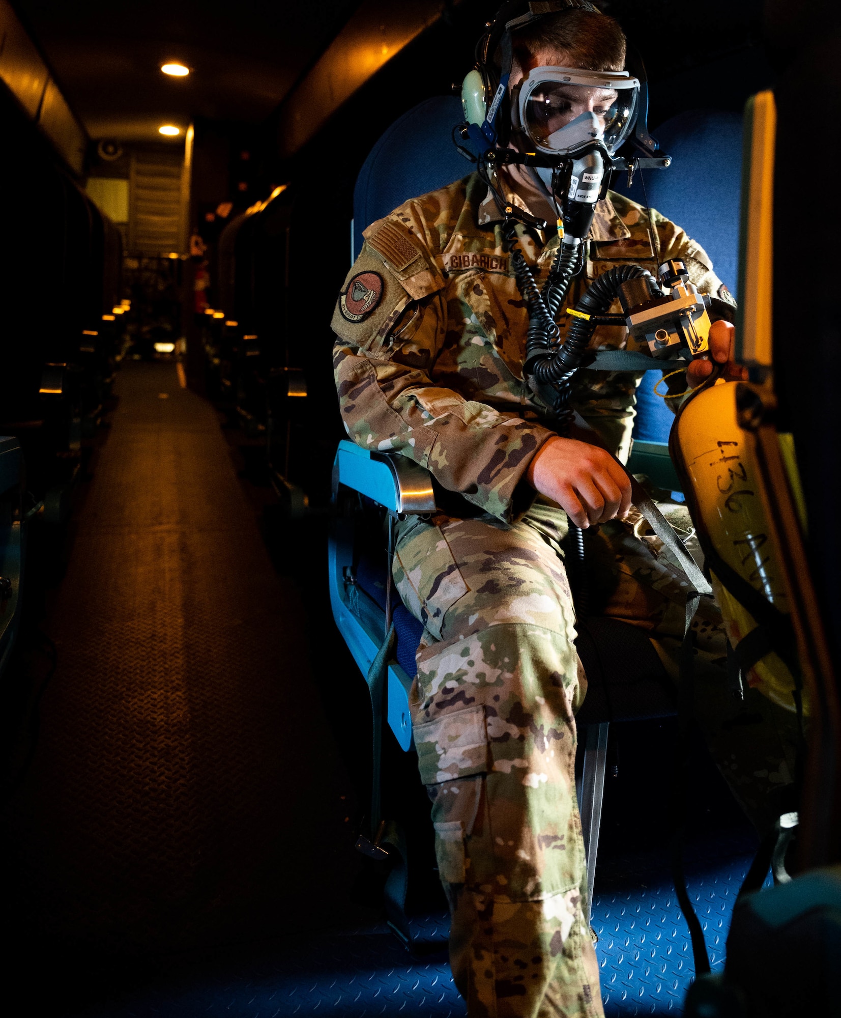 Senior Airman Tony Cibarich, 9th Airlift Squadron loadmaster, dons a 358 Quick Don Demist oxygen mask during a test and evaluation training flight, June 15, 2021. The 9th AS aircrew tested mask modifications for Air Mobility Command’s test and evaluation team which will assist in determining further modifications. (U.S. Air Force photo by Senior Airman Faith Schaefer)