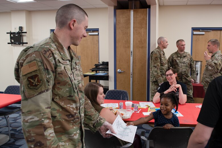 Photo of an Airman interacting with a family