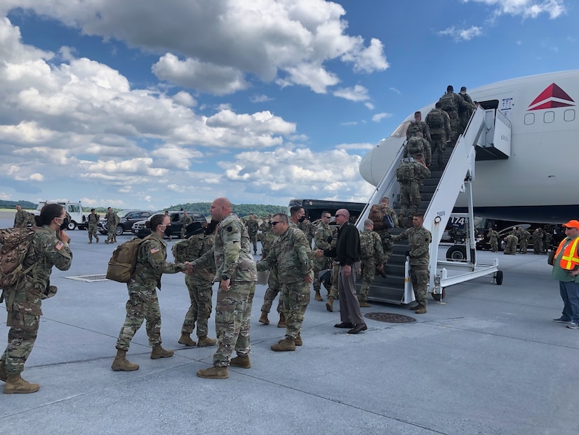 Soldiers from 1st Squadron, 104th Cavalry Regiment, 2nd Infantry Brigade Combat Team are greeted by Pennsylvania National Guard senior leaders as they board an airplane at Harrisburg International Airport in Middletown, Pa., on June 15, 2021. More than 200 Soldiers from 1-104th Cav. departed June 15 for a deployment to the Middle East. They will first travel to Fort Bliss, Texas, for pre-deployment training. (Photo by Joan Nissley)