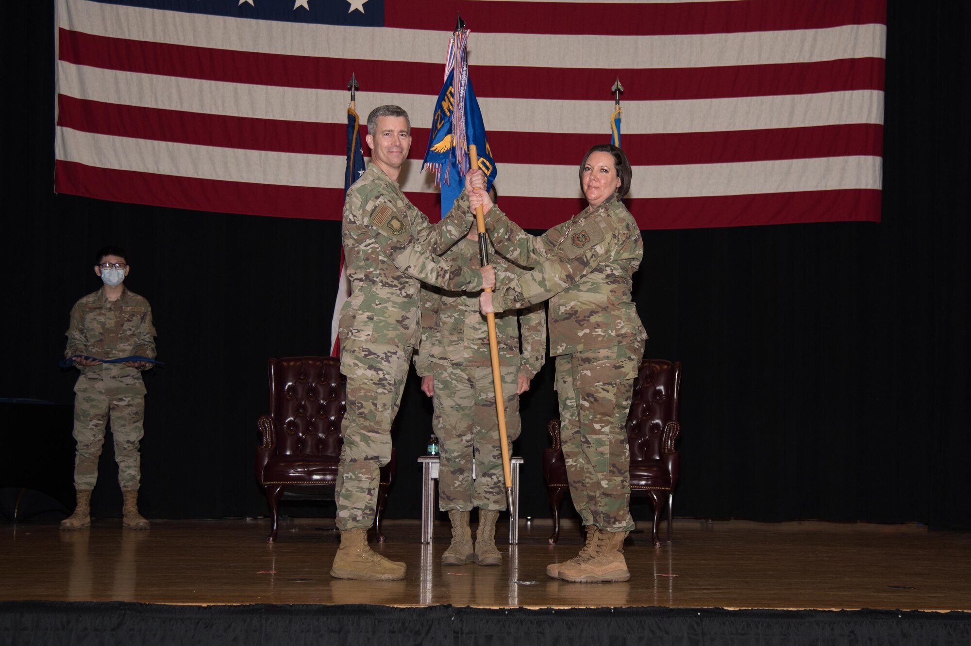 Lt. Col. Angela Yuhas, 22nd Medical Support Squadron outgoing commander, right, relinquishes command during an in-activation ceremony June 16, 2021, at McConnell Air Force Base, Kansas. During Yuhas’ command she led 98 Airmen over two years of service in the 22nd Medical Group. The in-activation ceremony was held in order to merge the squadron with the 22nd Healthcare Operations Squadron. (U.S. Air Force photo by Senior Airman Alexi Bosarge)