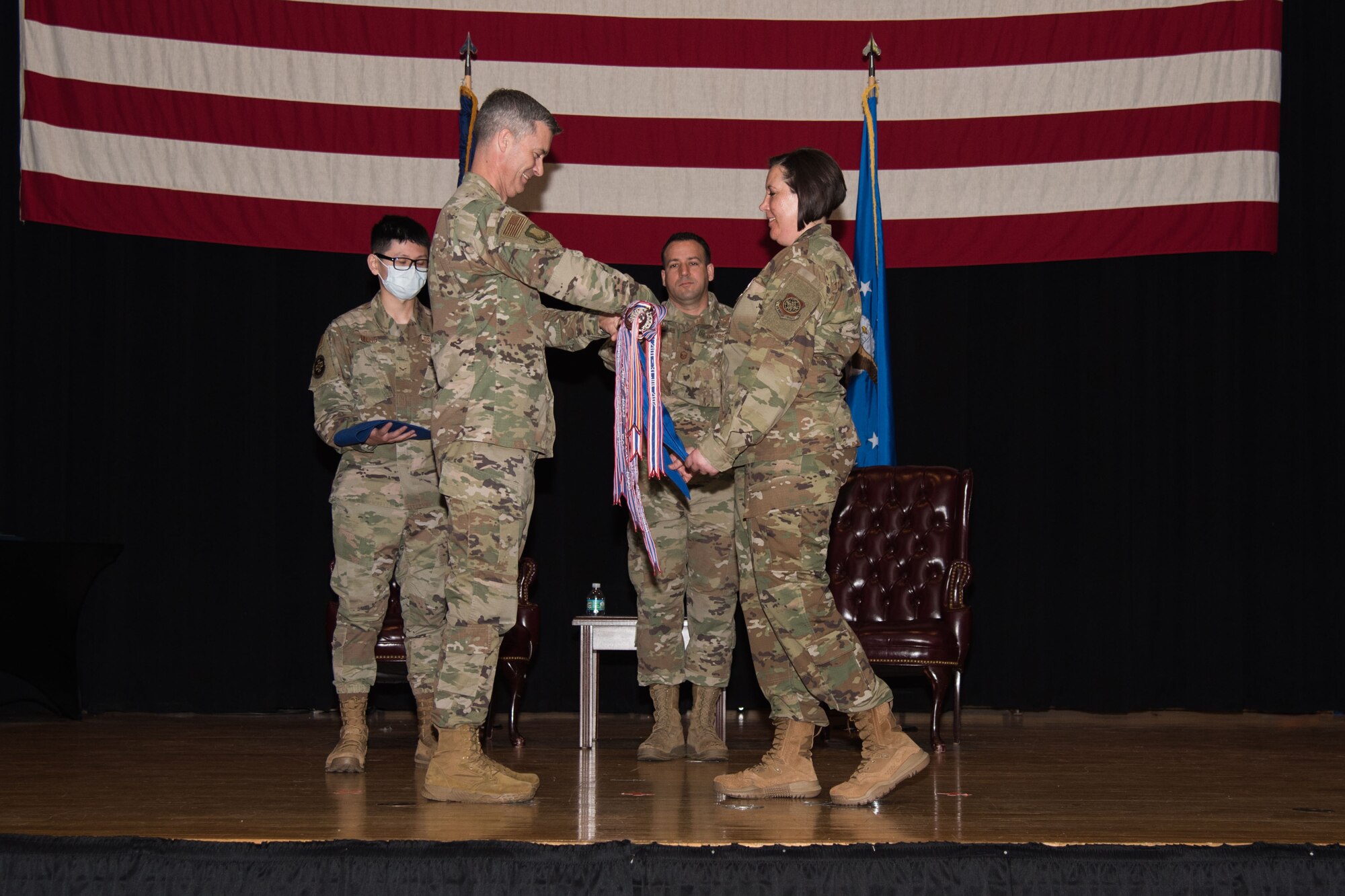 Col. Richard Tanner, 22nd Air Refueling Wing commander, left, and Lt. Col. Angela Yuhas, 22nd Medical Support Squadron outgoing commander, right, furl and case the 22d MDSS guidon June 16, 2021, at McConnell Air Force Base, Kansas. The 22d MDSS was constituted on Sept. 23, 1994, and activated on Oct. 1, 1994, on McConnell AFB. In-activation ceremonies are held in order to merge the squadron with the other units. (U.S. Air Force photo by Senior Airman Alexi Bosarge)