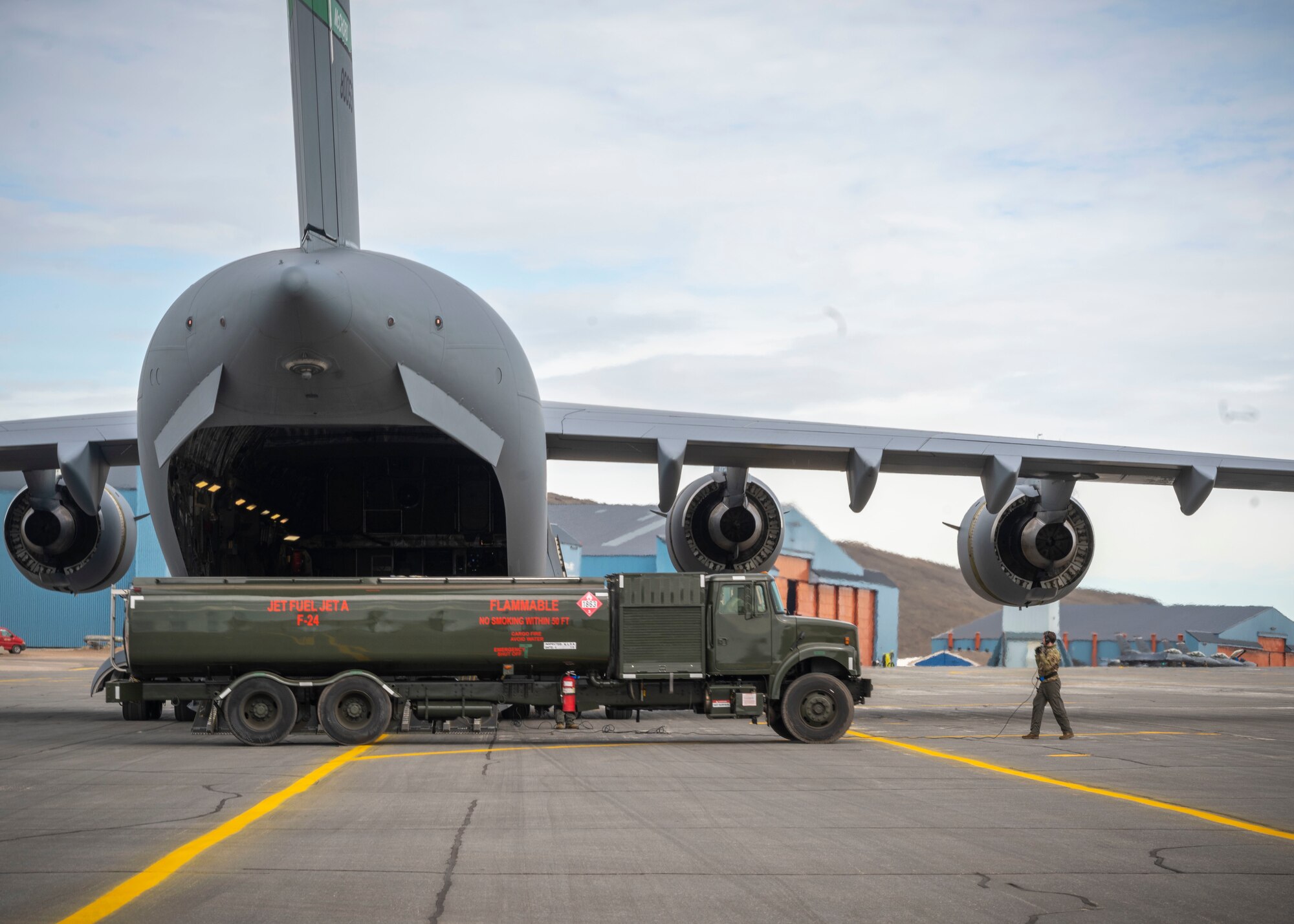 U.S. Air Force Airmen assigned to the 140th Wing and 4th Airlift Squadron preform a wet-wing defuel during exercise Amalgam Dart 21-01, June 16, 2021 at Thule Air Base, Greenland.