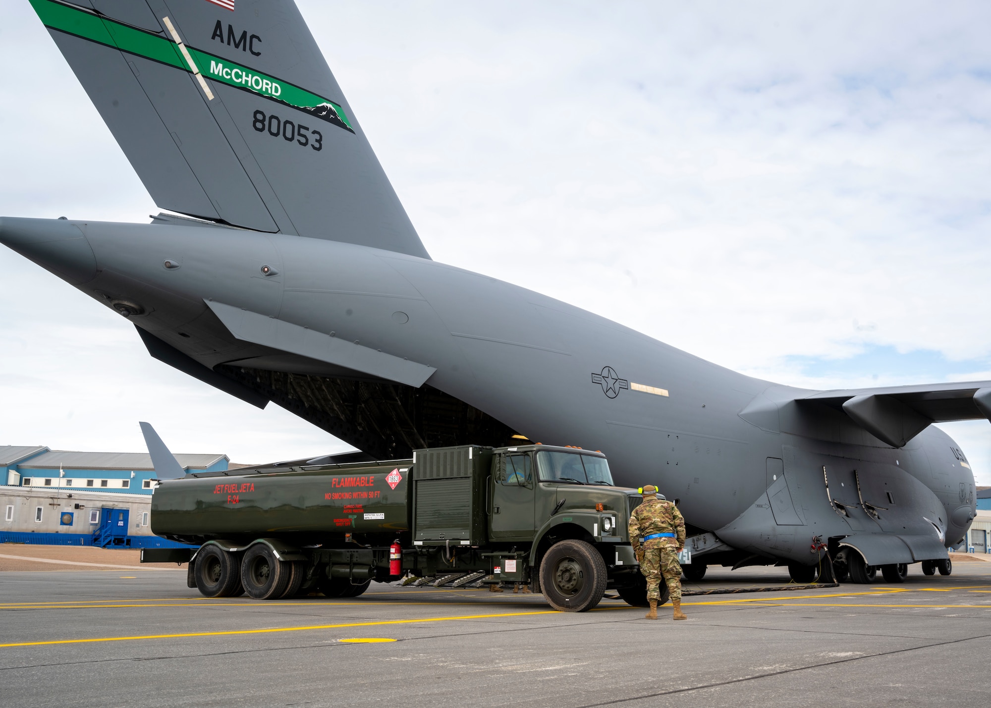 U.S. Air Force Airmen assigned to the 140th Wing and 4th Airlift Squadron preform a wet-wing defuel during exercise Amalgam Dart 21-01, June 16, 2021 at Thule Air Base, Greenland.