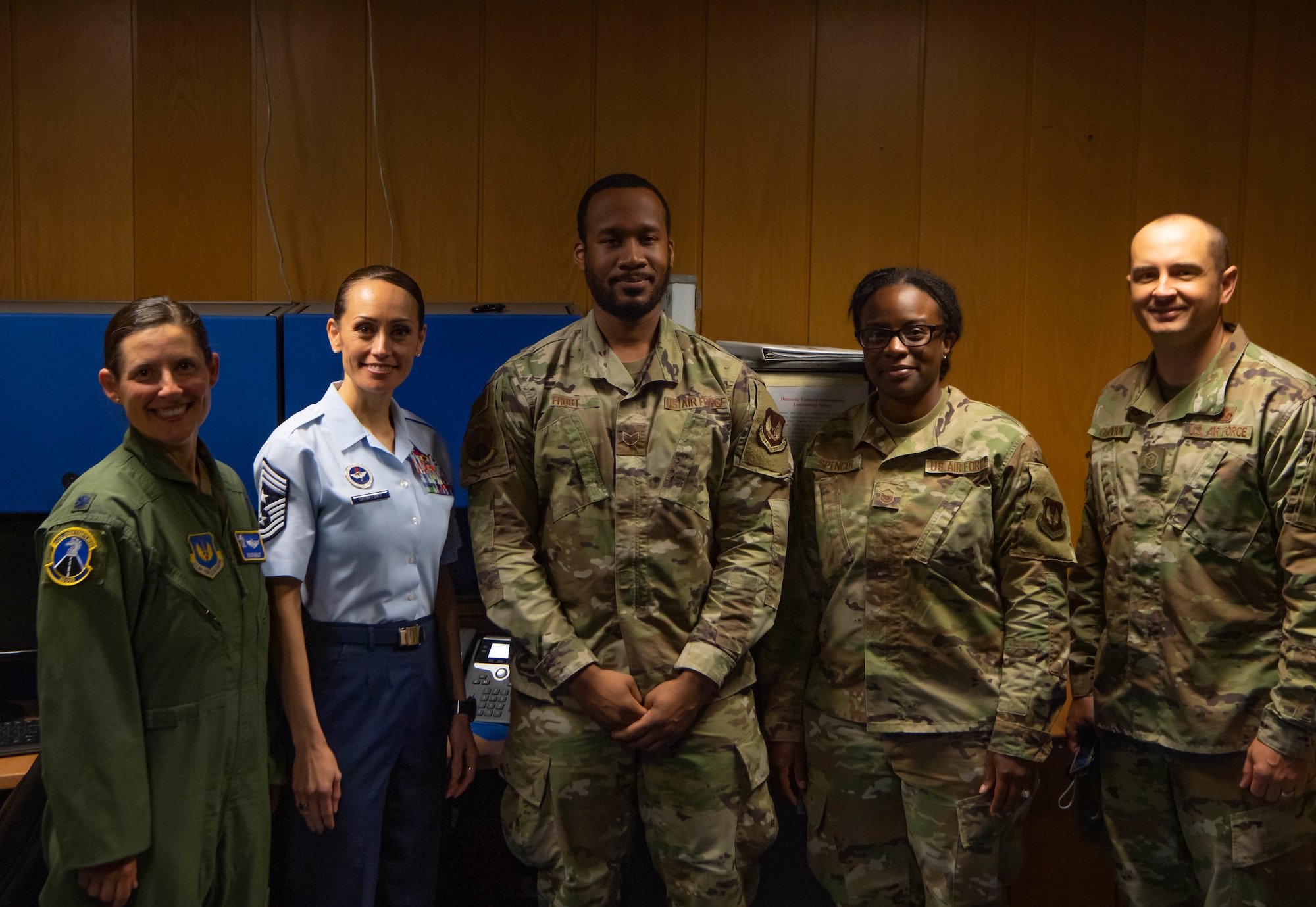 An Airman gets his picture taken with leadership.