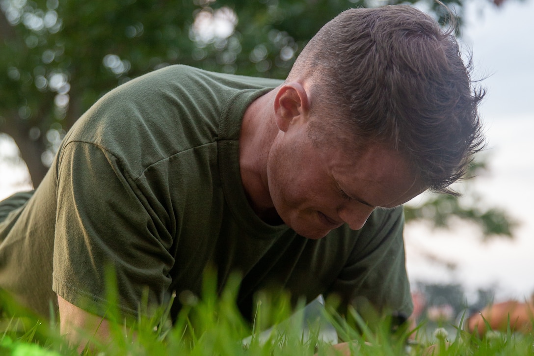 A U.S. Marine with 2d Marine Division (MARDIV) executes a plank during a physical fitness test as part of the Division Leadership Assessment Program (DLAP) on Camp Lejeune, N.C., June 15, 2021.  DLAP assesses the preparedness of 2d MARDIV's newly-assigned infantry captains by evaluating their mental, moral, and physical readiness for infantry company command, ensuring the division places the right leaders in front of the right companies at the right time. DLAP is a key component in the division’s mission to train and certify units that demonstrate apex levels of lethality, endurance, and comprehensive warfighting ability to be employed by their gaining higher headquarters immediately upon deployment.  (U.S. Marine Corps photo by Lance Cpl. Brian Bolin Jr.)
