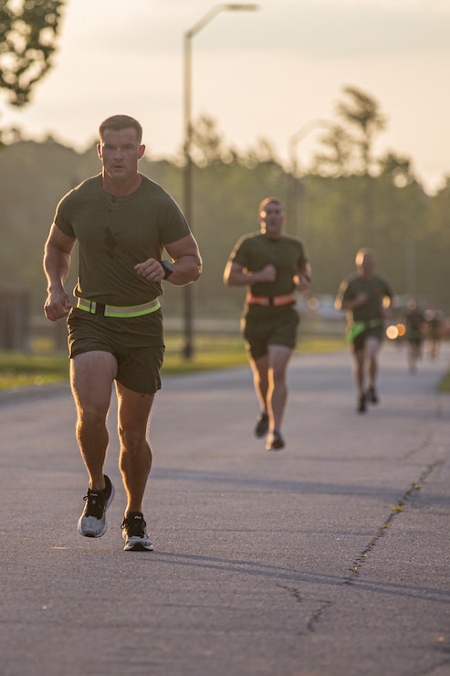 U.S. Marines with 2d Marine Division (MARDIV) run during a physical fitness test as part of the Division Leadership Assessment Program (DLAP) on Camp Lejeune, N.C., June 15, 2021.  DLAP assesses the preparedness of 2d MARDIV's newly-assigned infantry captains by evaluating their mental, moral, and physical readiness for infantry company command, ensuring the division places the right leaders in front of the right companies at the right time. DLAP is a key component in the division’s mission to train and certify units that demonstrate apex levels of lethality, endurance, and comprehensive warfighting ability to be employed by their gaining higher headquarters immediately upon deployment.  (U.S. Marine Corps photo by Lance Cpl. Brian Bolin Jr.)