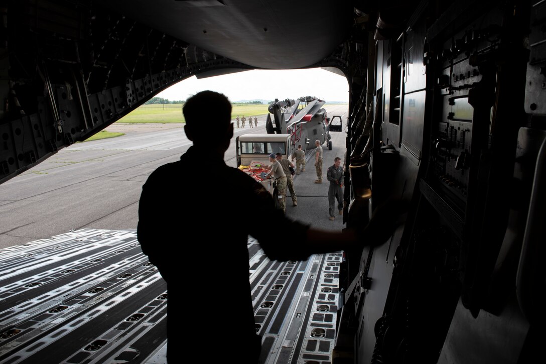 U.S. Air Force Airman 1st Class Cody Kennedy, a loadmaster with the 167th Operations Support Group, operates the ramp controls during the loading of a UH-60M Black Hawk helicopter onto a C-17 Globemaster III aircraft at the Wheeling Ohio County Airport, Wheeling, West Virginia, June 8, 2021. As part of a joint training exercise, 167th Airlift Wing loadmasters trained with maintainers from C and D Company, 1st Battalion, 150th Aviation Regiment.