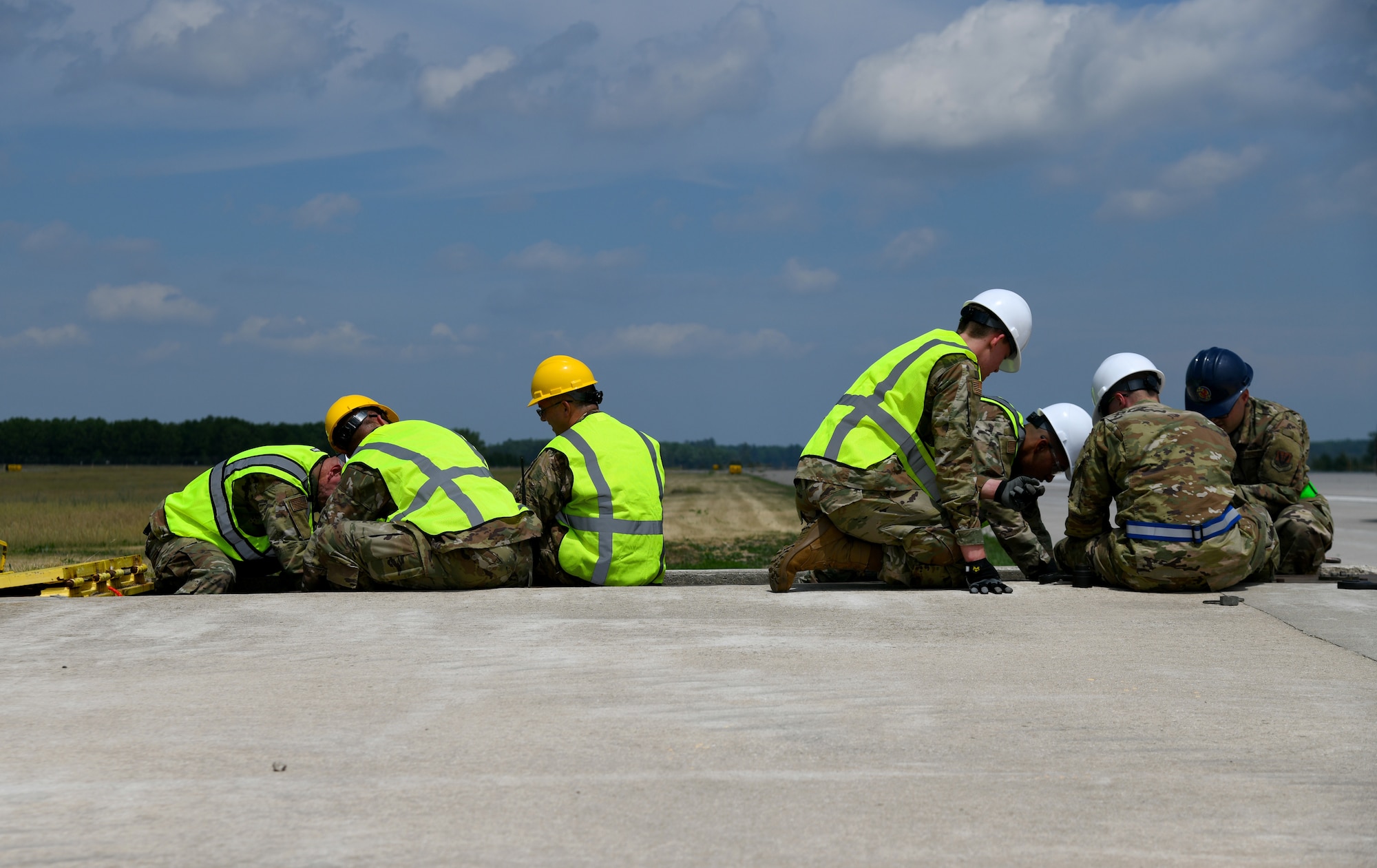 Michigan Air National Guard power production Airmen from the 110th Civil Engineer Squadron and the Alpena Combat Readiness Training Center (CRTC) replace a fairlead beam June 8, 2021, at the Alpena Combat Readiness Training Center, Michigan. The Alpena CRTC replaced their aircraft arresting system, which is designed to help stop aircraft with tail hooks in case of emergency. (U.S. Air National Guard photo by Staff Sgt. Tristan D. Viglianco)