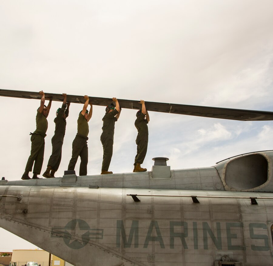 U.S. Marine Corps CH-53E aircraft maintainers attached to Marine Heavy Helicopter Squadron (HMH) 361, Marine Aircraft Group 16, 3rd Marine Aircraft Wing, perform routine maintenance at Naval Air Station Fallon, Nevada, June 16, 2021. Maintainers are essential in 24/7 mission readiness because they preserve and improve the reliability, safety, and lethality of Marine Corps Aviation with their attention to detail and  timely requests.  (U.S. Marine Corps photo by Lance Cpl. Rachaelanne Woodward)