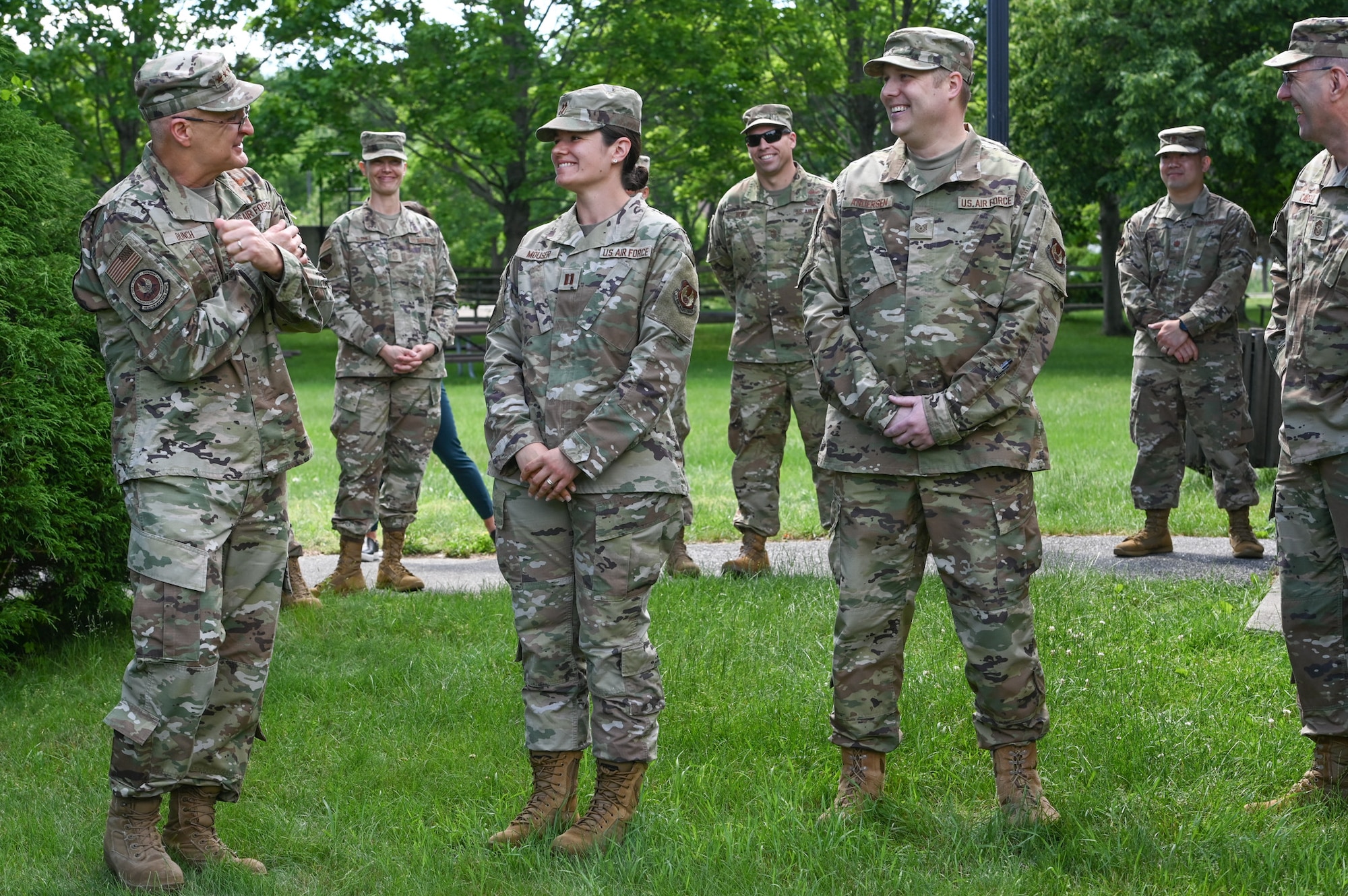 Gen. Arnold W. Bunch, Jr., Air Force Materiel Command commander, coins Capt. Jenifer Mouser, 66th Medical Squadron officer in charge of Laboratory and Radiology, during a visit to the clinic at Hanscom Air Force Base, Mass., June 16, while Tech. Sgt. Joshua Anderson, 66 MDS noncommissioned officer in charge of Public Health, and others look on. Bunch presented his coin to Anderson and Mouser during the MDS visit. (U.S. Air Force photo by Todd Maki)