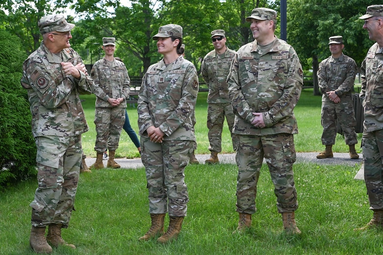 Gen. Arnold W. Bunch, Jr., Air Force Materiel Command commander, coins Capt. Jenifer Mouser, 66th Medical Squadron officer in charge of Laboratory and Radiology, during a visit to the clinic at Hanscom Air Force Base, Mass., June 16, while Tech. Sgt. Joshua Anderson, 66 MDS noncommissioned officer in charge of Public Health, and others look on. Bunch presented his coin to Anderson and Mouser during the MDS visit. (U.S. Air Force photo by Todd Maki)