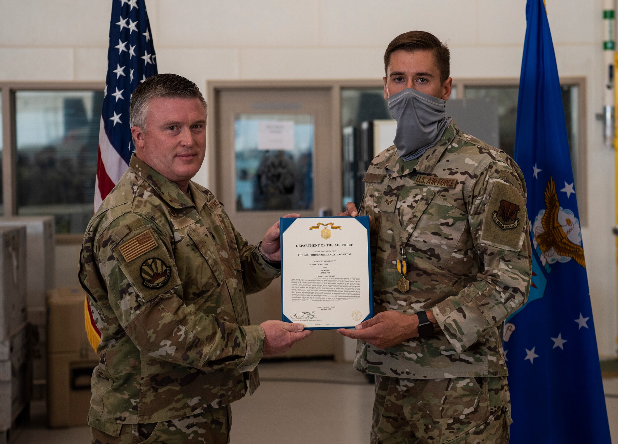 Senior Airman Levi is presented with an Air Force Commendation Medal.