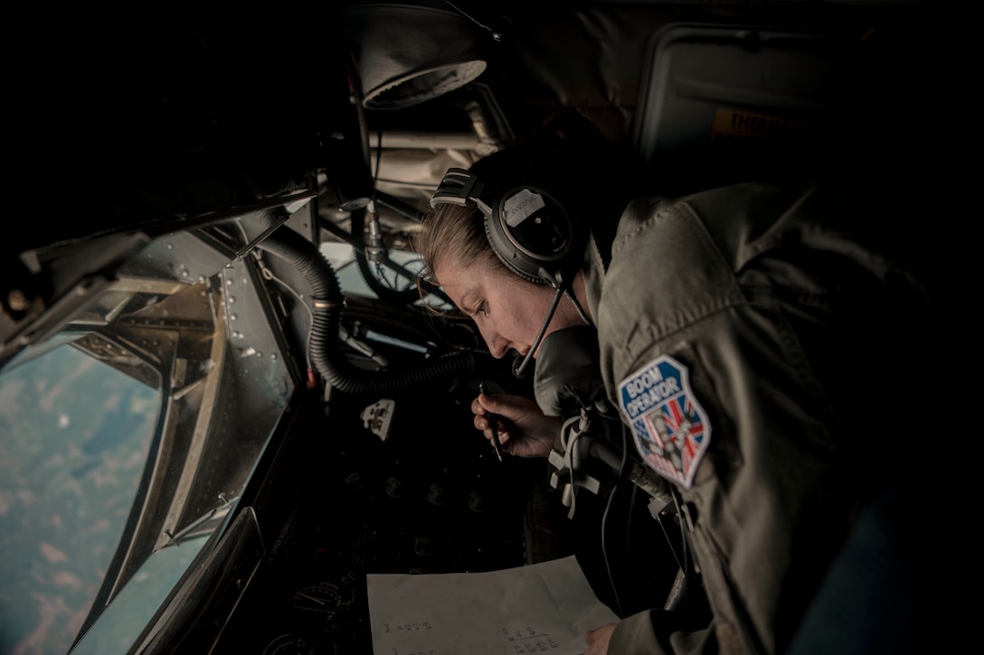 An airmen sits in a cockpit.