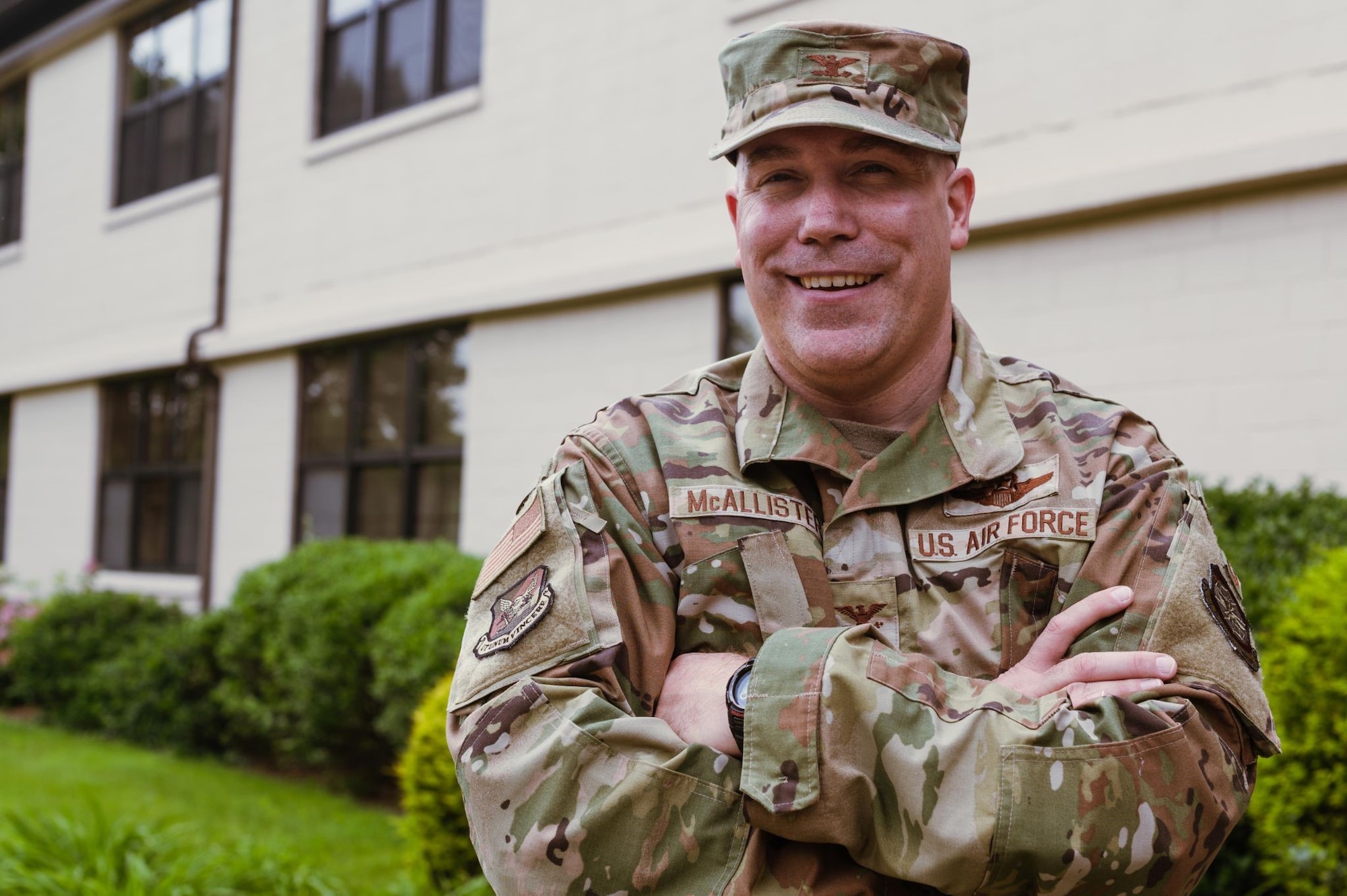 U.S. Air Force Col. Robert “Preach” McAllister poses in front of the wing building