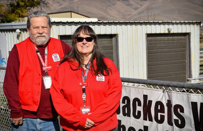 Joe and Charlene Douglas standing in front of a fence