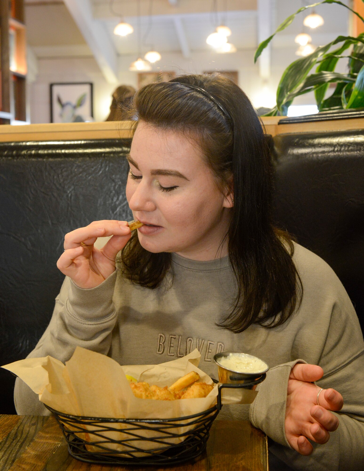 U.S. Air Force Staff Sgt. Mikhaila Brown, national tactical integration analyst with the 381st Intelligence Squadron, enjoys a meal April 21, 2021, in Anchorage, Alaska.