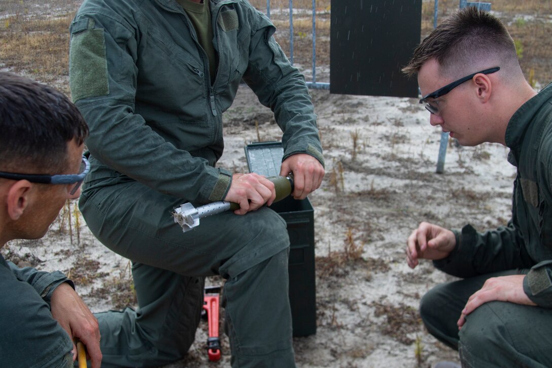 U.S. Marine Corps Staff Sgt. Mark Frick, left, and U.S Marine Corps Sgt. Jonathan Cosgrove, with Explosive Ordnance Disposal (EOD), Headquarters and Headquarters Squadron, pack a mortar with C-4 at Marine Corps Air Station Cherry Point, North Carolina, June 9, 2021. EOD and Carteret County Special Response Teams conducted a joint training ordnance range where they demonstrated the effects different ordnances would have on the body. (U.S. Marine Corps photo by Lance Cpl. Symira Bostic)