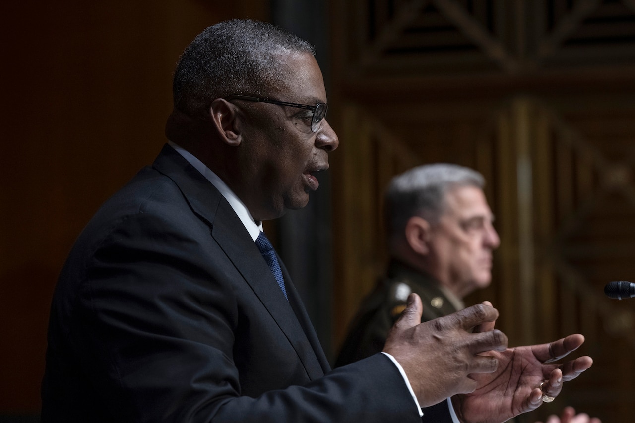 Secretary Austin gestures while speaking to the Senate committee.