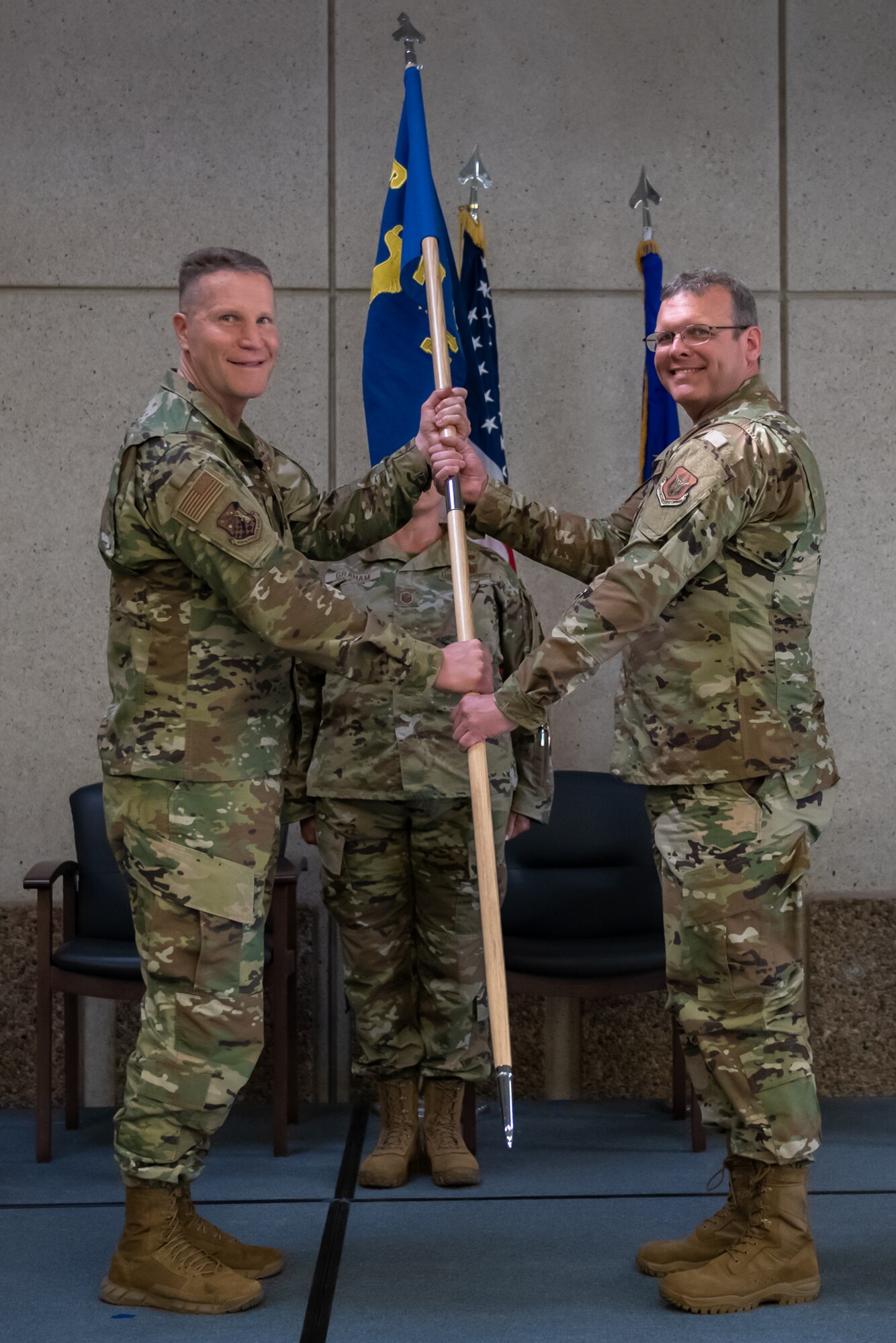 Col. Matthew Fritz, 419th Fighter Wing commander, passes the squadron flag to Lt. Col. Adam Cole, the new commander of the 419th Medical Squadron, during a change of command ceremony June 6, 2021, at Hill Air Force Base, Utah.