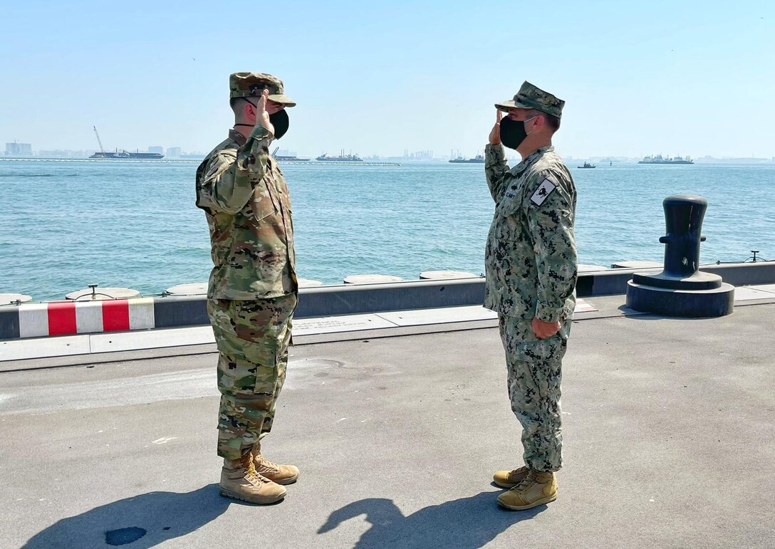 Major Grant Wanamaker reaffirms his oath of office after being promoted to Major on the new $49.6 million steel and concrete pier at Naval Support Activity Bahrain. Wanamker helped oversee the construction of the pier while working as a project manager for the U.S. Army Corps of Engineers Transatlantic Middle East District.