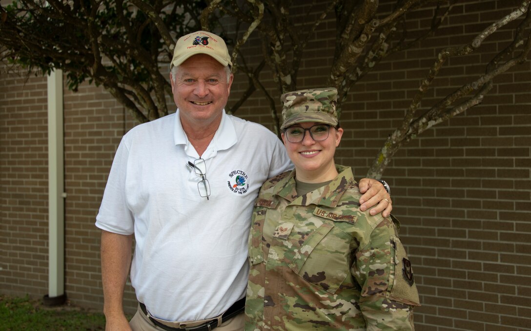 Photo of father and daughter standing next to eachother