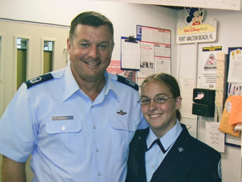 Photo of father and daughter standing next to eachother