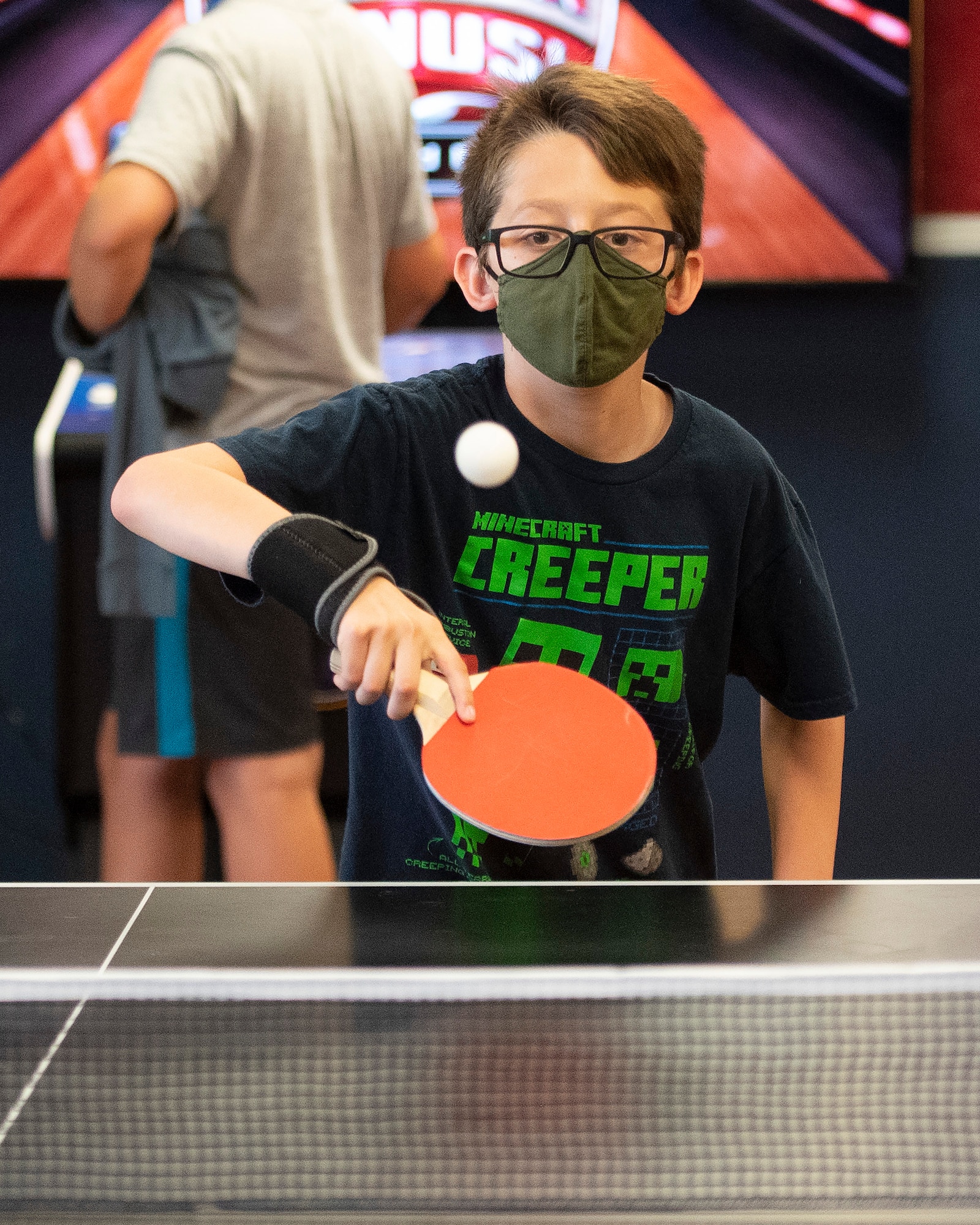 Julian Serna, 12, plays a game of pingpong June 10, 2021, in the Prairies Youth Center’s new game room. The 88th Force Support Squadron is opening the room full of free arcade games June 18. (U.S. Air Force photo by R.J. Oriez)