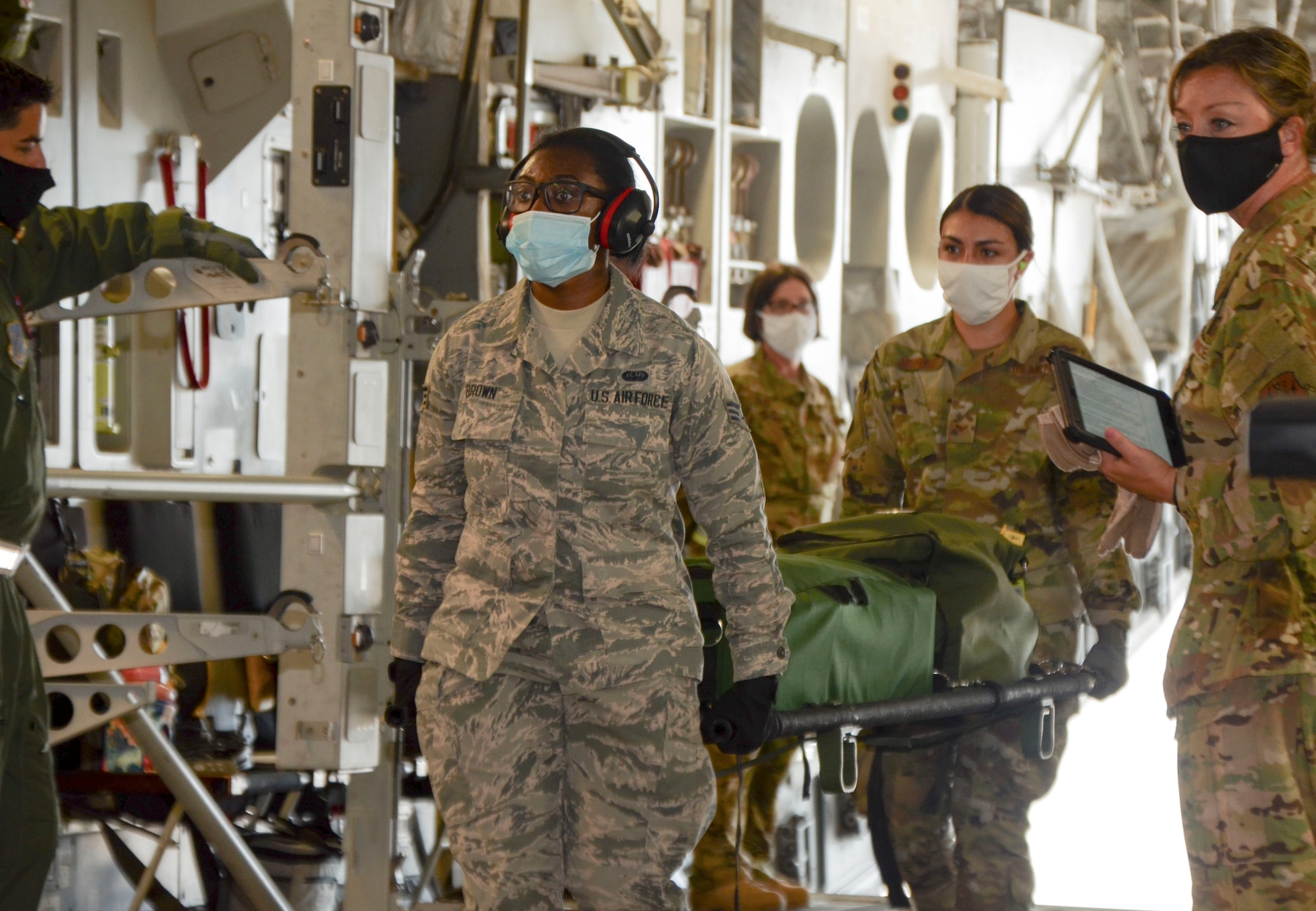 Airmen assigned to the 36th Aeromedical Evacuation Squadron carry a litter onboard a C-17 Globemaster III at the Mississippi Air National Guard’s Combat Readiness and Training Center in Gulfport, Mississippi, July 20, 2020. Airmen from the 183rd AES and 36th AES collaborated during multiple training missions to accomplish in-flight patient care onboard both the C-17 and C-130 Hercules. (U.S. Air National Guard Photo by Senior Master Sgt. Jeannine Smith)
