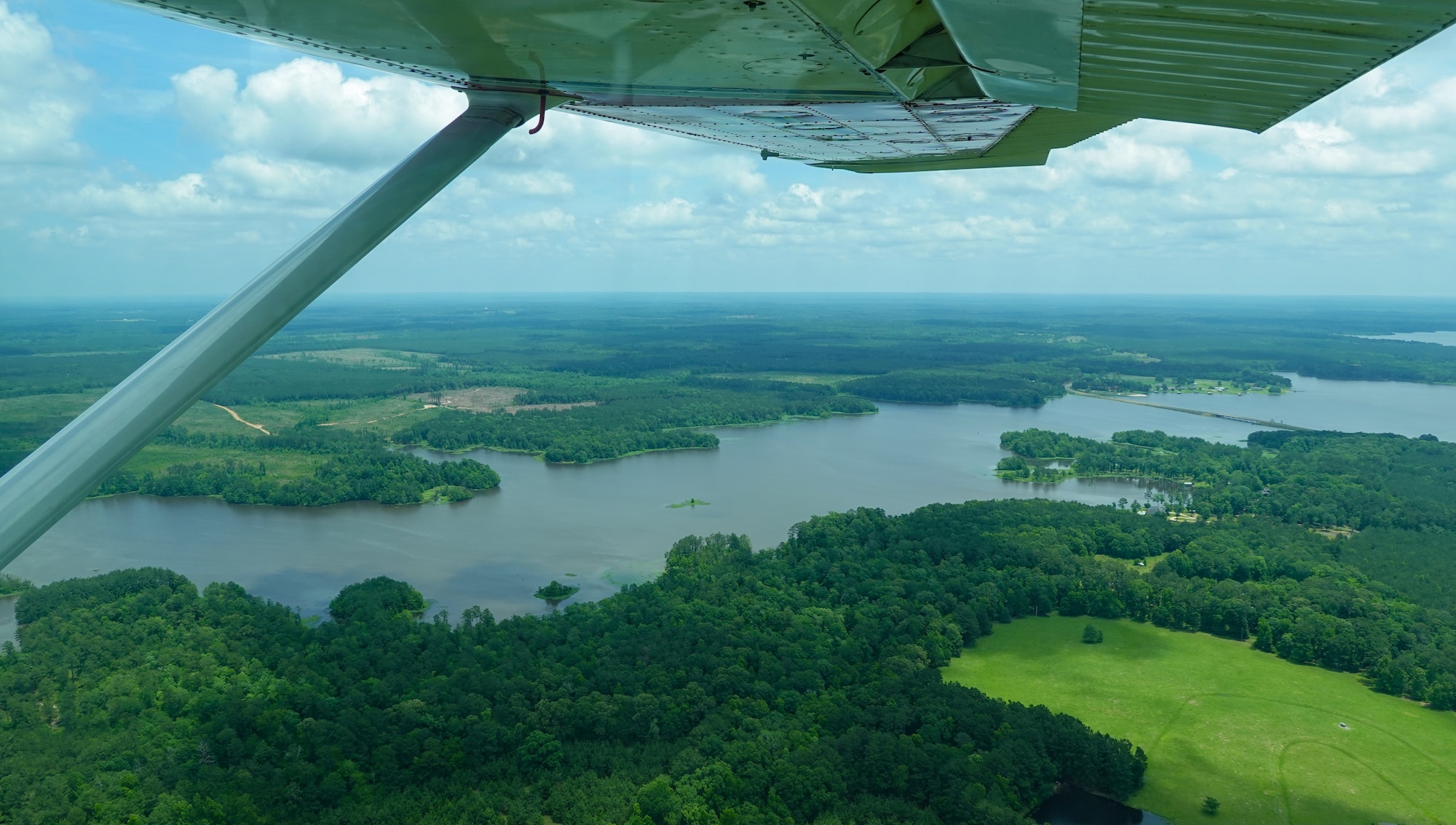 A Civil Air Patrol Cessna 182 Skylane, flies over Lake Bistineau, Louisiana, during a Mid-Air Collision Avoidance safety flight May 28, 2021. MACA visits are conducted at various airports within a 50 nautical mile radius of Barksdale in which the CAP is tasked to move military personnel to help support Air Force mission safety requirements in different locations. (Courtesy photo by Master Sgt. Steven Vance Jr.)