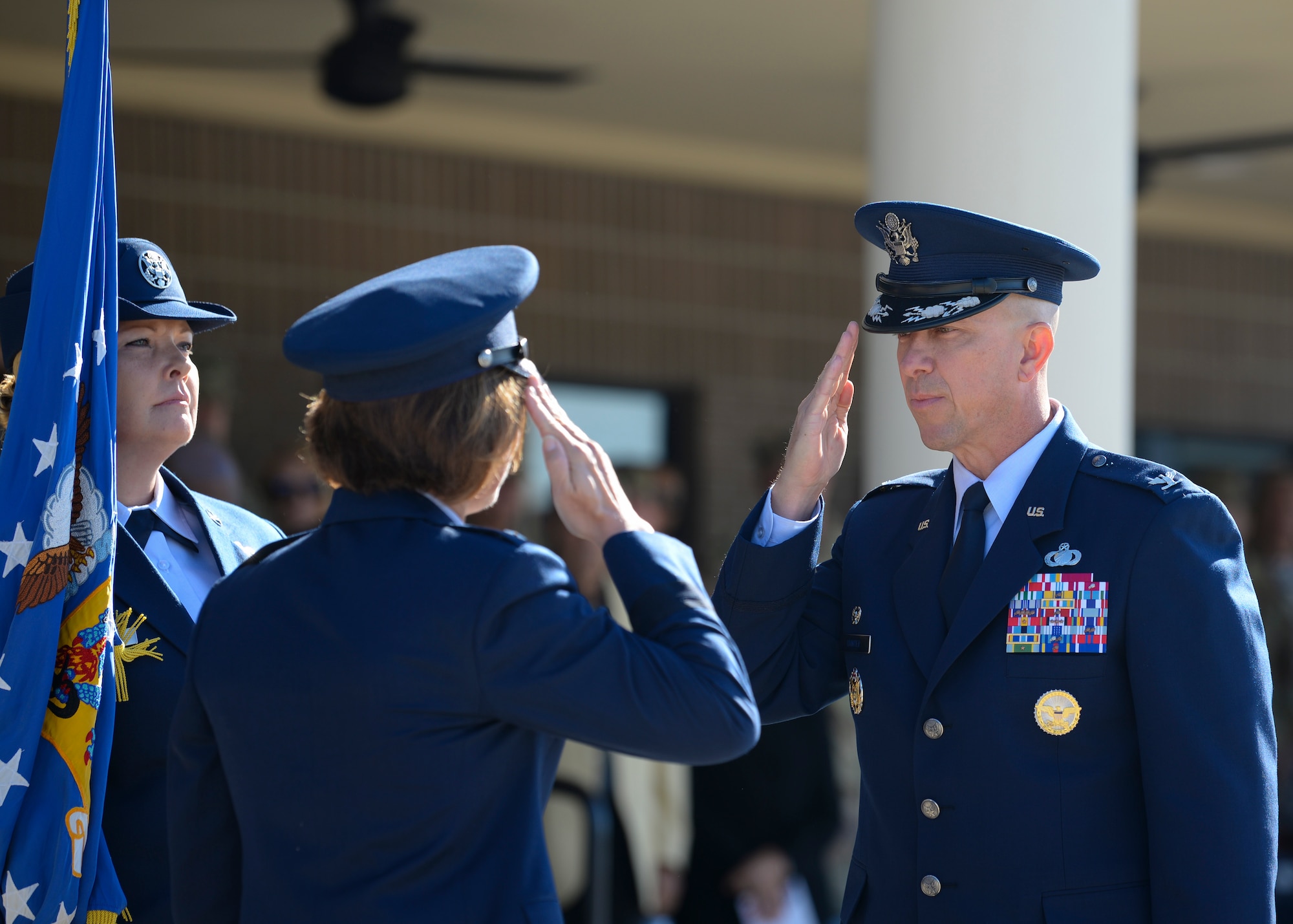 U.S. Air Force Col. William Hunter, 81st Training Wing commander, salutes Maj. Gen. Andrea Tullos, Second Air Force commander, during the change of command ceremony on the Levitow Training Support Facility drill pad at Keesler Air Force Base, Mississippi, June 17, 2021. The ceremony is a symbol of command being exchanged from one commander to the next by the handing-off of a ceremonial guidon. Hunter assumed command of the 81st TRW from Col. Heather Blackwell. (U.S. Air Force photo by Senior Airman Spencer Tobler)
