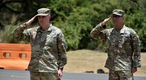 Two military people saluting