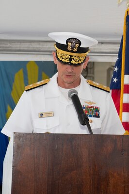 Rear Adm. Gregory Huffman reads his orders during the Carrier Strike Group (CSG) 12 Change of Command ceremony a