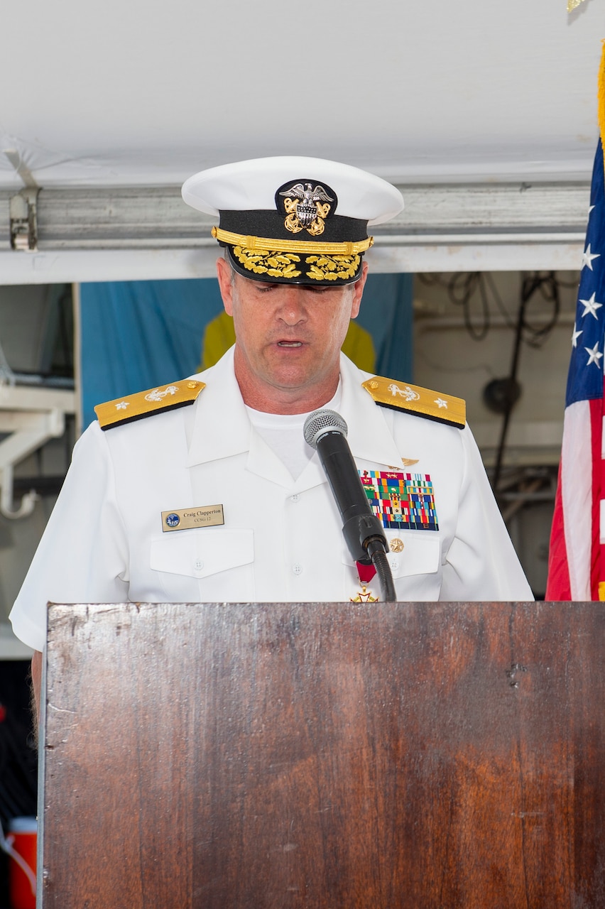 Rear Adm. Craig Clapperton, Commander, Carrier Strike Group (CSG) 12, reads his orders during the CSG-12 Change of Command ceremony aboard the guided-missile destroyer USS Bulkeley (DDG 84) June 17.