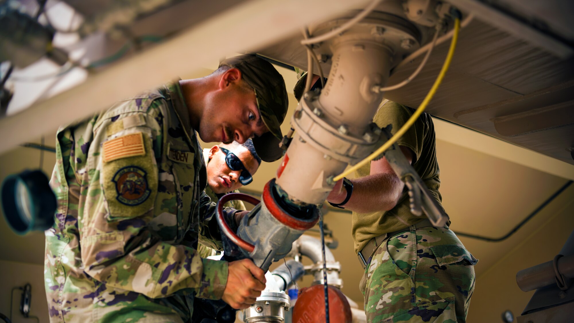 U.S. Air Force Airmen from the 380th Expeditionary Civil Engineer Squadron water & fuel systems maintenance and the 380th Expeditionary Logistic Readiness Squadron fuels flight perform maintenance on a fuels system at Al Dhafra Air Base, United Arab Emirates, June 14, 2021.
