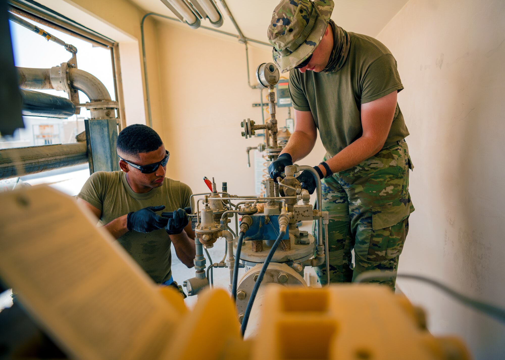U.S. Air Force Airmen from the 380th Expeditionary Civil Engineer Squadron water & fuel systems maintenance and the 380th Expeditionary Logistic Readiness Squadron fuels flight perform maintenance on a fuels system at Al Dhafra Air Base, United Arab Emirates, June 14, 2021.