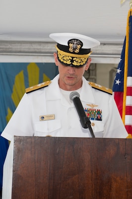 Rear Adm. Gregory Huffman reads his orders during the Carrier Strike Group (CSG) 12 Change of Command ceremony a