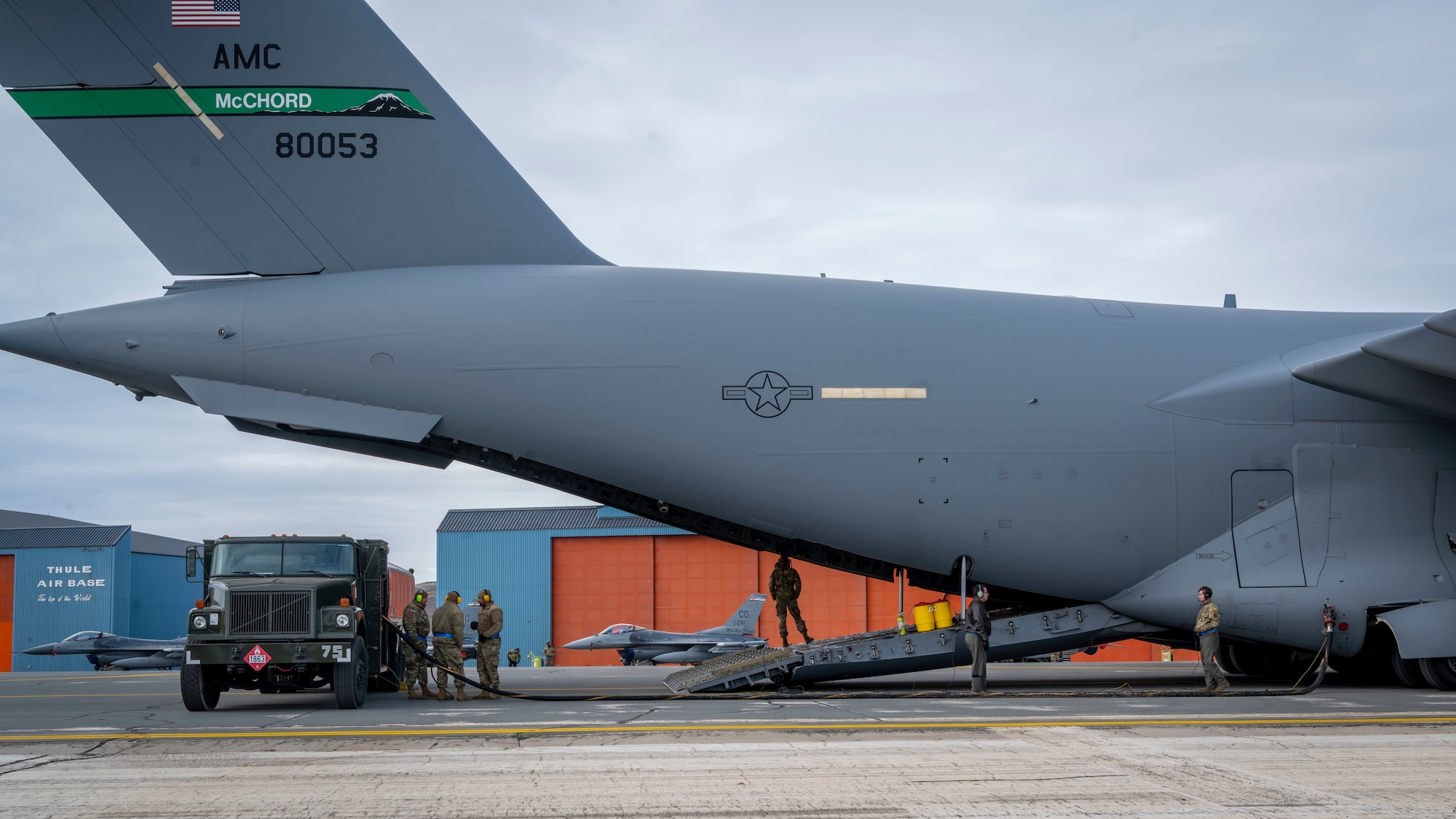 U.S. Air Force Airmen assigned to the 140th Wing and 4th Airlift Squadron preform a wet-wing defuel during exercise Amalgam Dart 21-01, June 16, 2021 at Thule Air Base, Greenland.